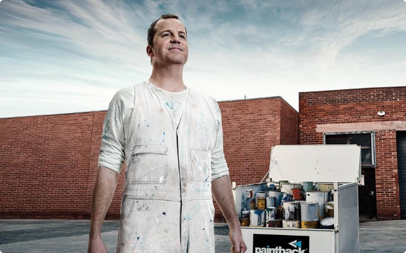 Man looking at sky with background of paintbuckets